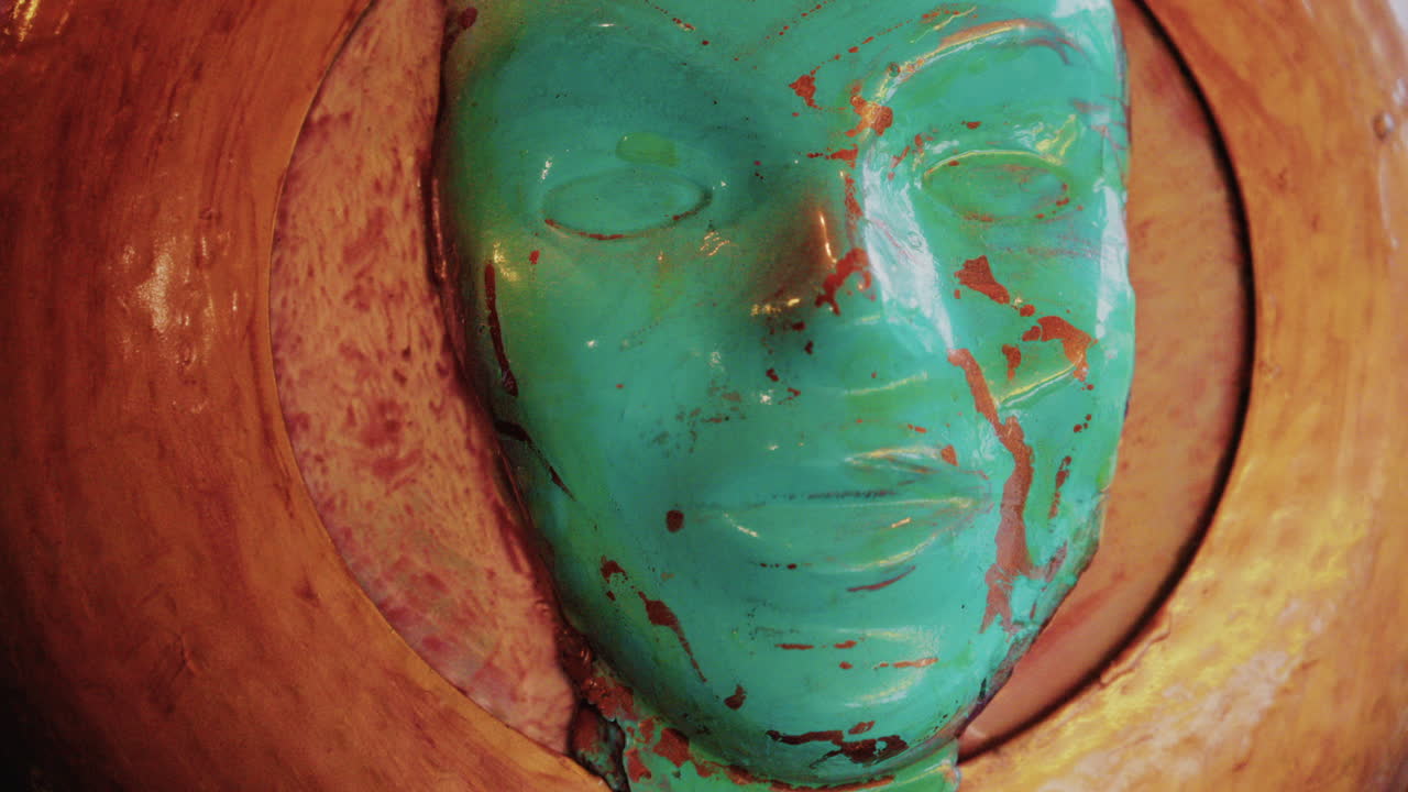 Modern red and white yacht docked in calm marina waters with clear reflections