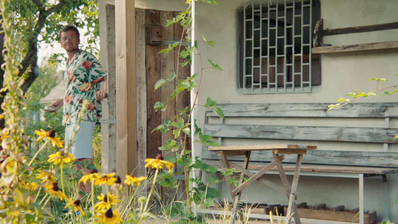 Man relaxing on a porch in a garden