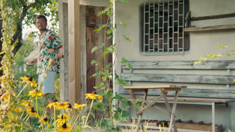 man relaxing on a porch in a garden