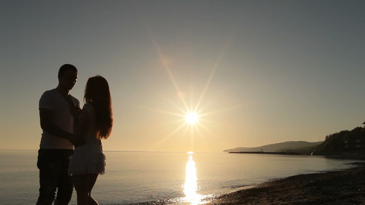 Couple on beach. Silhouette of romantic couple enjoying together on beach
