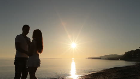 couple on beach. silhouette of romantic couple enjoying together on beach