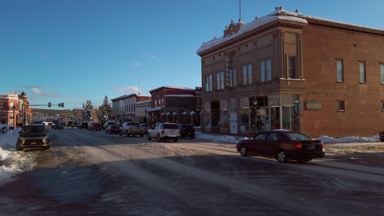 Snowy Winter Day on a Town Street with Cars and Buildings