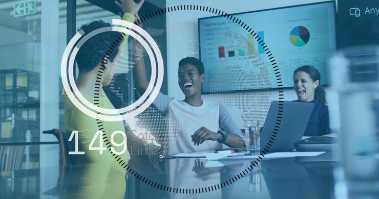 Left woman raising arm, team high-fiving at glass table while HUD overlay incrementing KPI