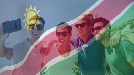 group of friends taking selfie, namibia flag animation over them