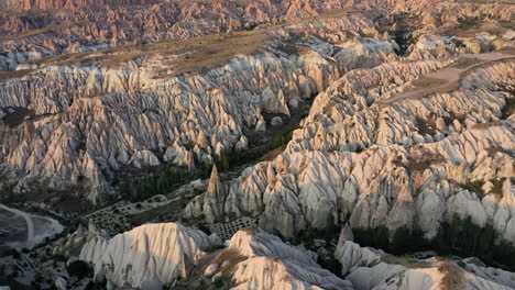 epic cinematic aerial drone shot above the rocky valley and fairy chimneys of cappadocia, turkey