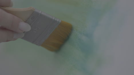 close-up of an artist painting a canvas