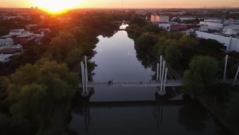 aerial view over people walking on a bridge during sunset in culiacán rosales, mexico