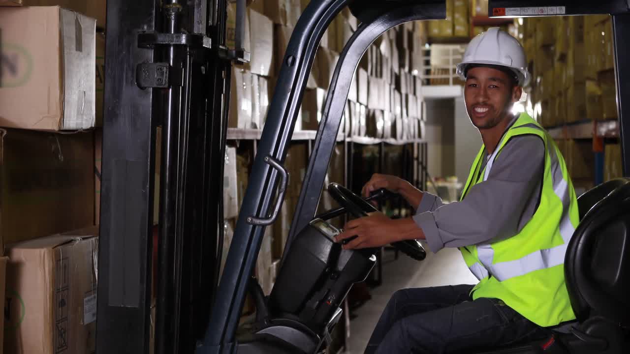 Forklift driver smiling at camera
