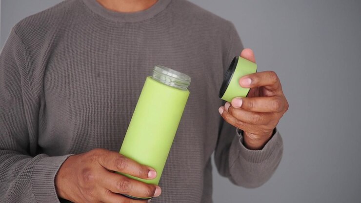 Person Opening and Closing a Green Reusable Water Bottle