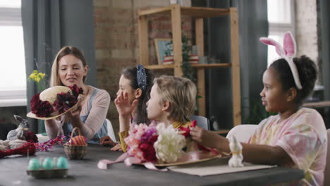 Female Teacher and Children Making Easter Decorations