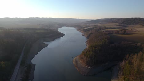 Aerial-overview-over-the-water-reservoir-Kretinka-near-Letovice-in-the-Czech-Republic,-Central-Europe-at-sunset