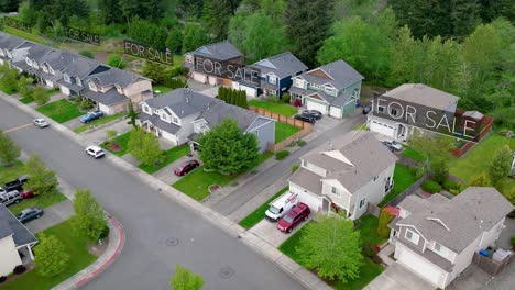 Aerial-view-of-houses-with-"FOR-SALE"-signs-animating-over-them