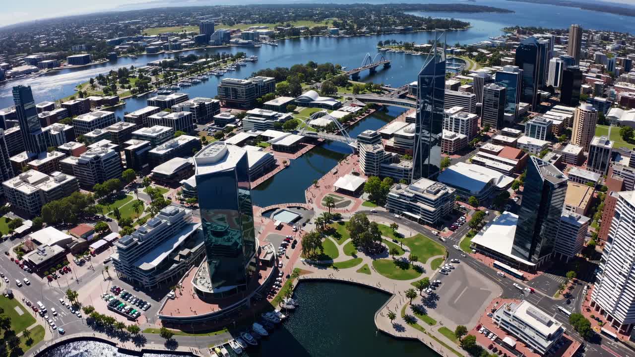 Aerial view of a vibrant cityscape with modern skyscrapers and waterways, perfect for a video