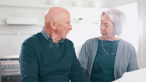 senior couple kiss with paperwork for budget