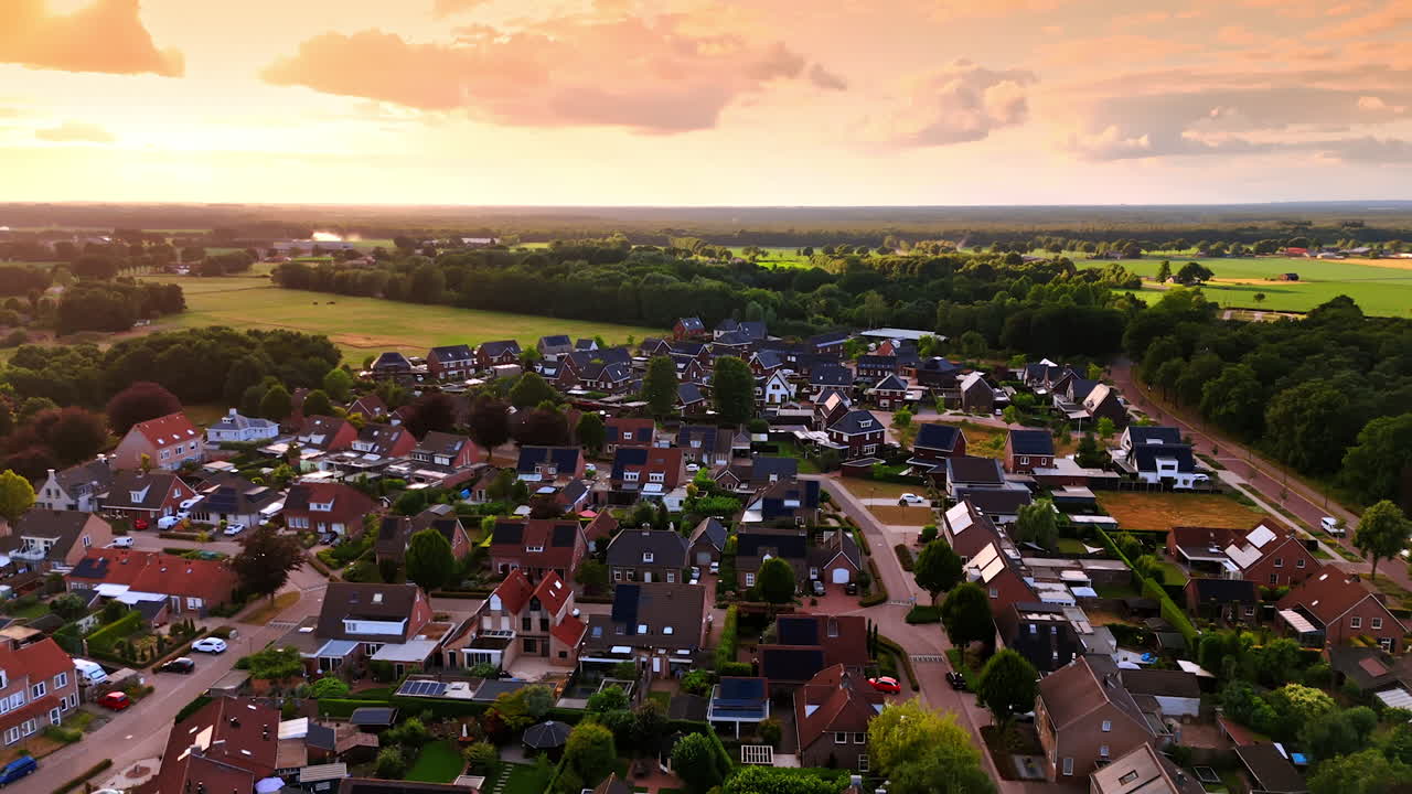 Cozy rural area with lovely houses at sunset. Stunning nature surrounds the residential area. Drone footage