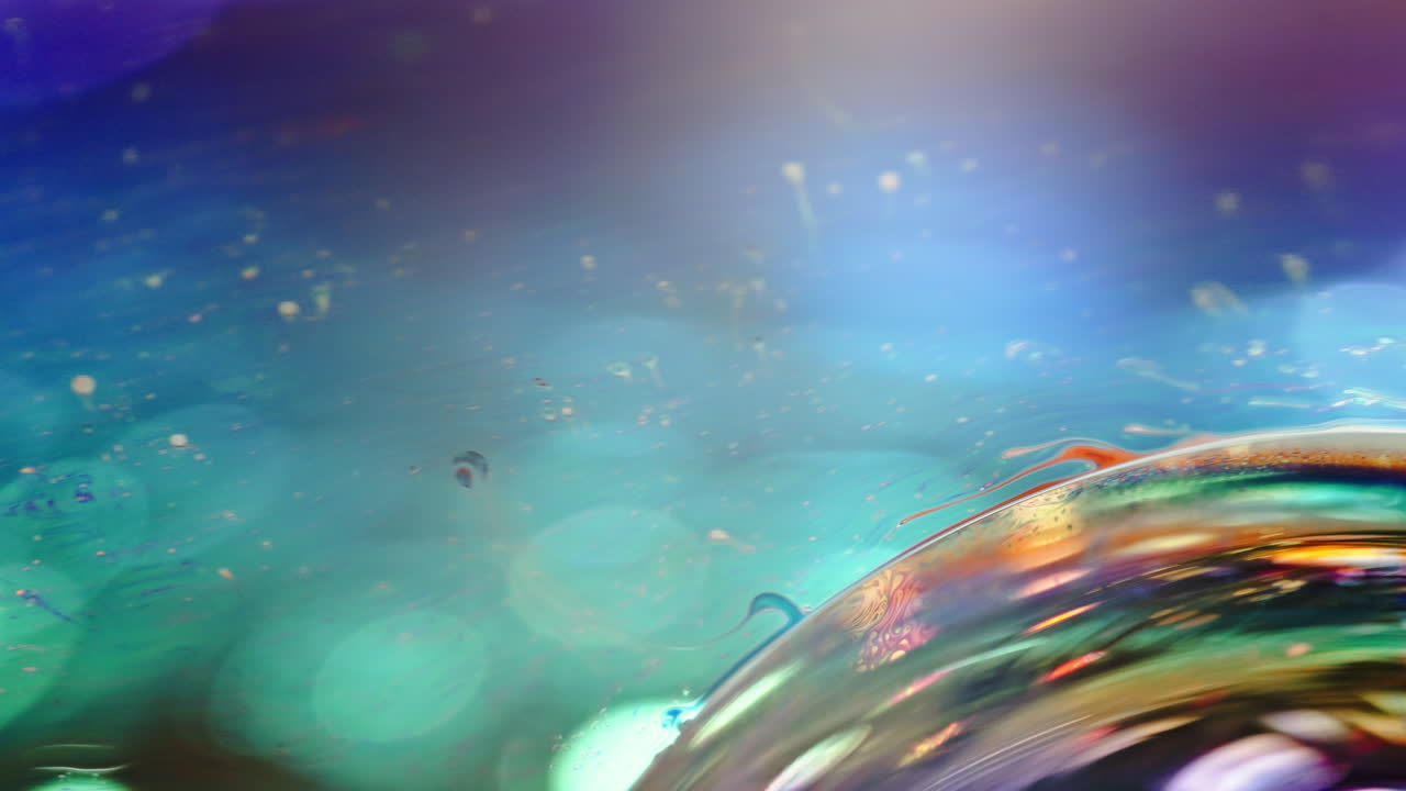 Abstract macro shot of a colorful soap bubble with reflections and bokeh light effects
