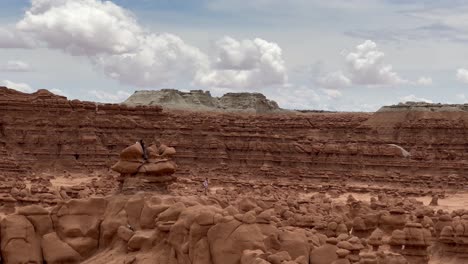 People-climbing-on-hoodoo-rocks-in-Goblin-Valley-State-Park-in-Utah---panorama