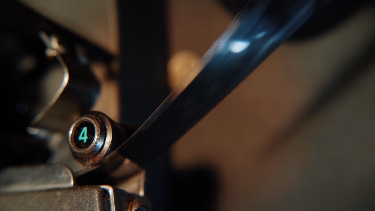 Close-up of Movie Film Strip Moving Through Vintage Projector