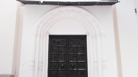 ornate church door in winter