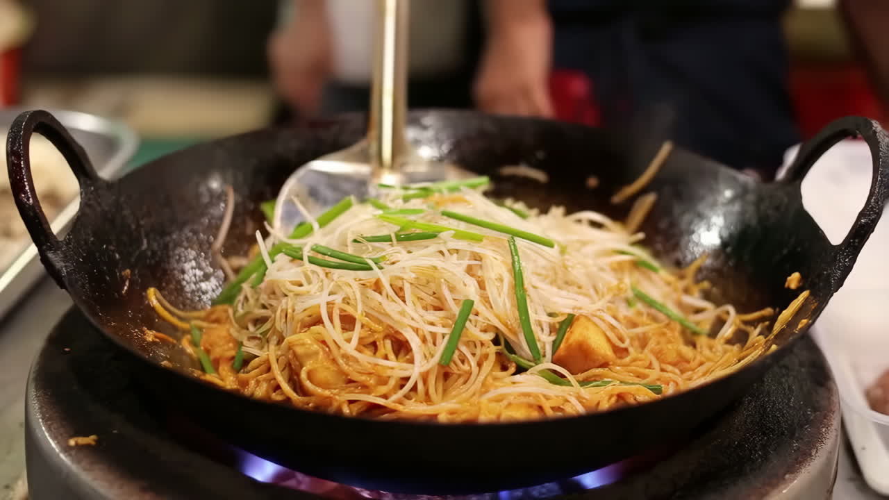 Chef Stir-Frying Noodles in a Wok