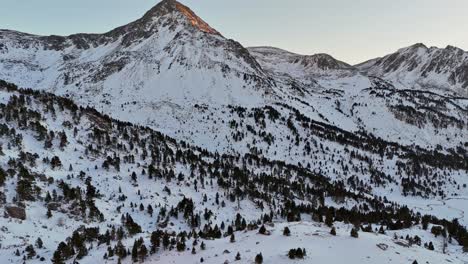 drone footage of snowy mountains and forest in the pyrenees mountains