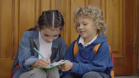 children doing homework together outside
