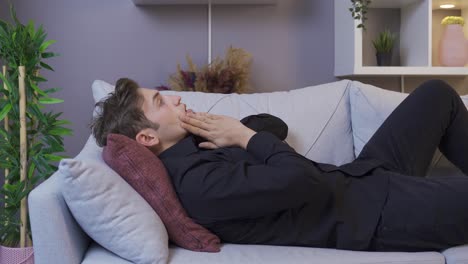 Frustrated-young-man-sitting-on-the-sofa.