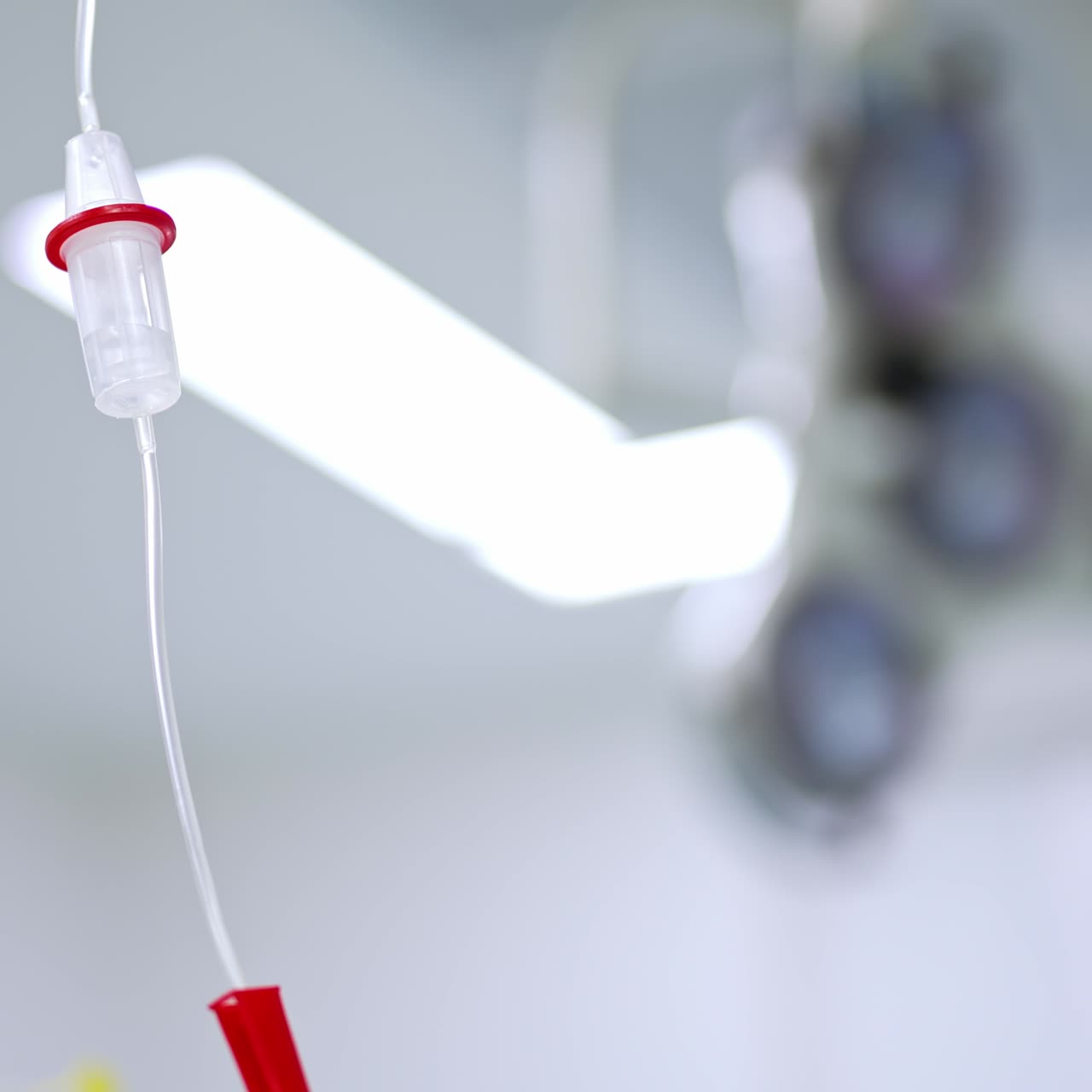 Plastic reservoir for medication of a drop counter. Necessary equipment for operations in modern clinics. Blurred backdrop