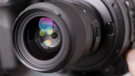 close-up on the opening and closing of the aperture of a lens mounted on a cinema camera