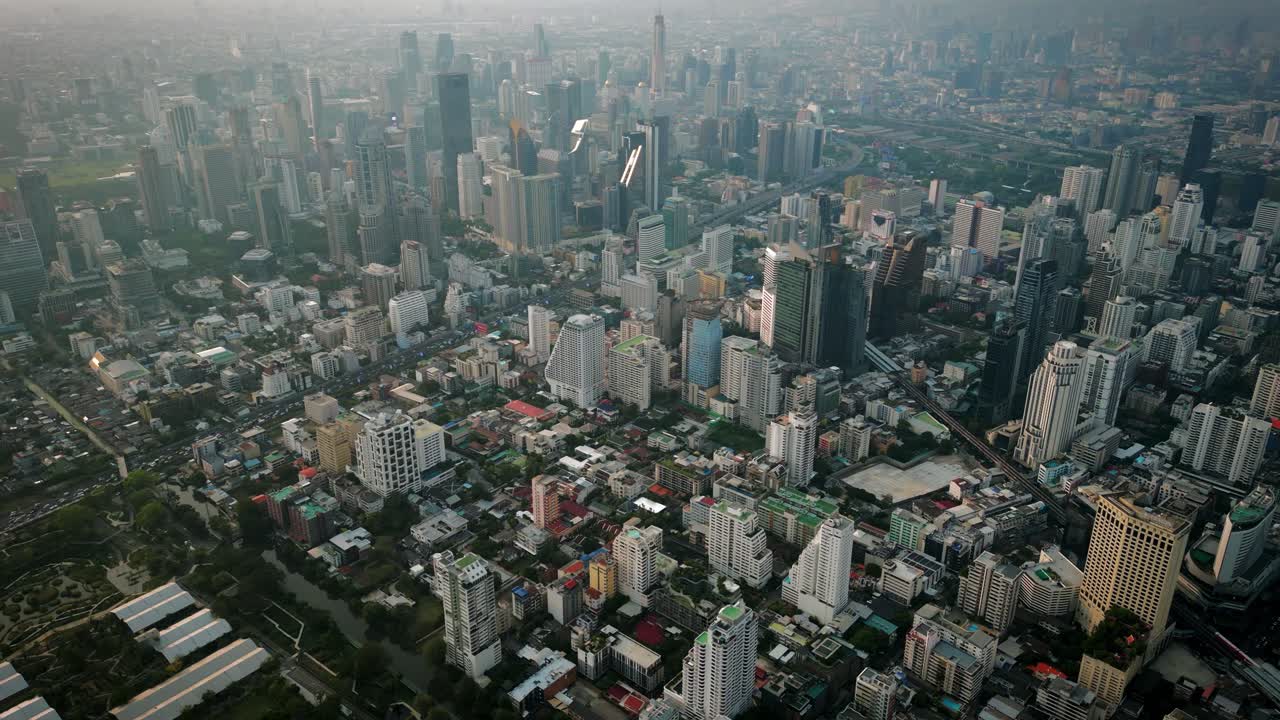 Aerial Scenic Drone Footage of the Skyline of Downtown Bangkok, Thailand Covered in Smog during Sunset during the Smokey Burning Season