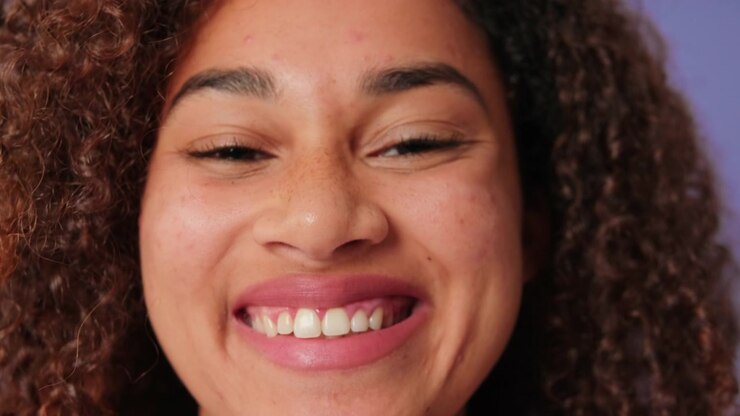 Close-up Portrait of a Smiling Young Woman with Curly Hair