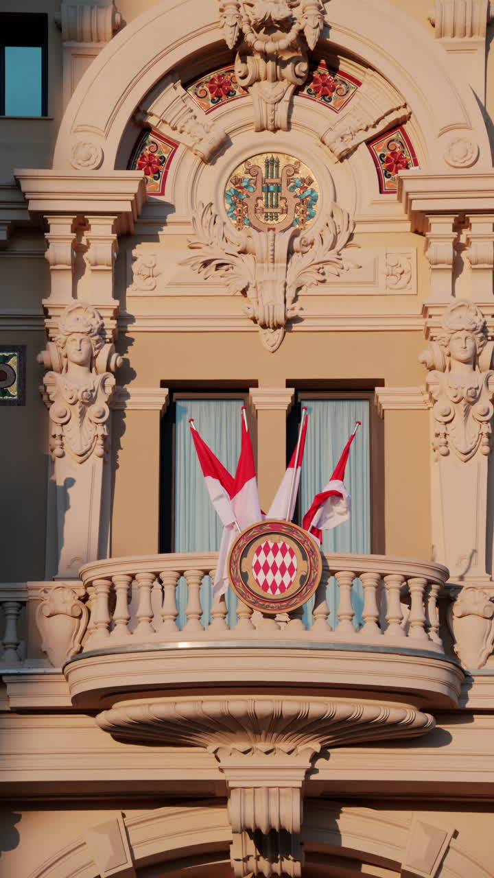 Monte Carlo, Monaco - October 24, 2024: The coat of arms of Monaco and multiple flags waving on the Monte Carlo Casino