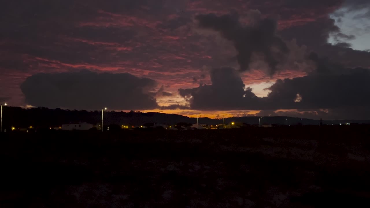 Dramatic clouds paint the twilight sky with fiery hues. A serene and beautiful end to the day. Perfect for nature, romance, and peaceful moments.