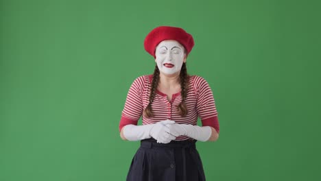 mime artist crying over green background