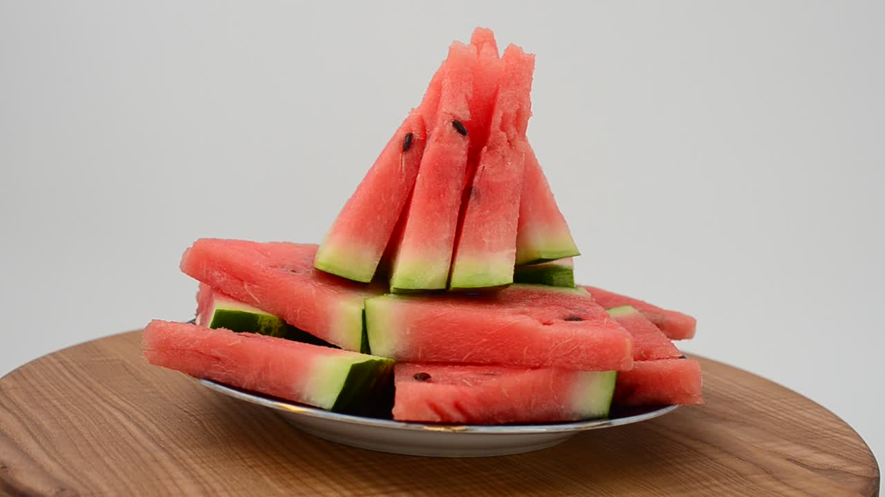 Shooting of a watermelon on a kitchen board. Shooting in the movement