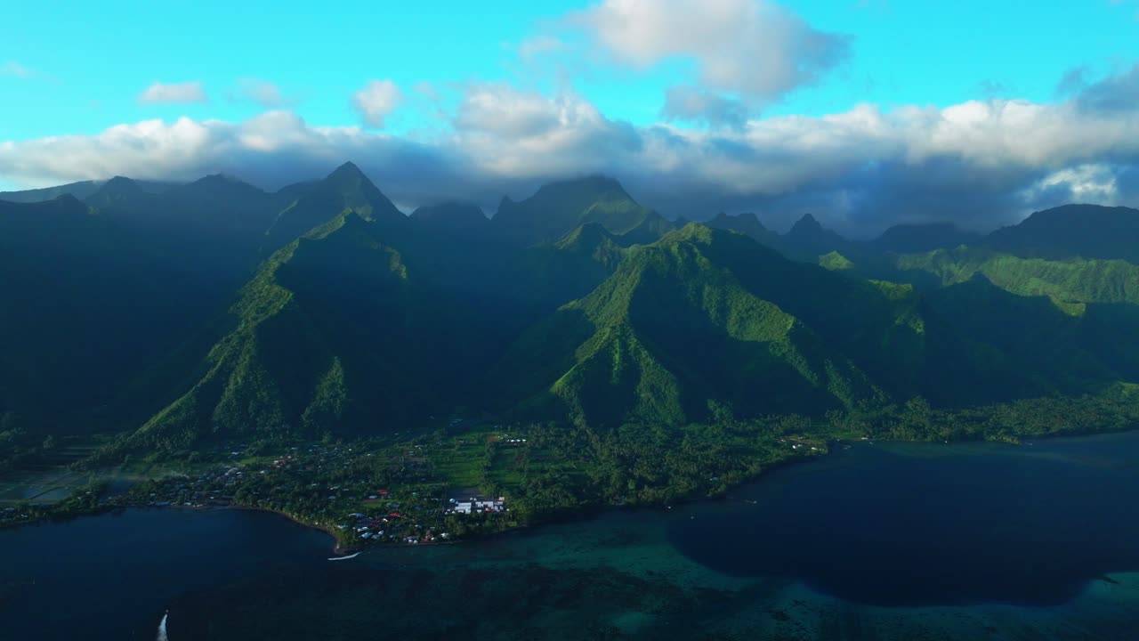 Sunset towering mountain peaks surf reef break channel boats Teahupoo Wave Tahiti French Polynesia aerial drone incredible island landscape clouds Olympics Moorea Bora Bora Papeete circle right