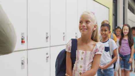 Video-of-happy-video-of-teacher-and-happy-diverse-pupils-waiting-for-entering-classroom