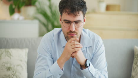 businessman puts on glasses and starts to think