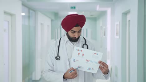 sikh indian doctor explaining medical reports to patient