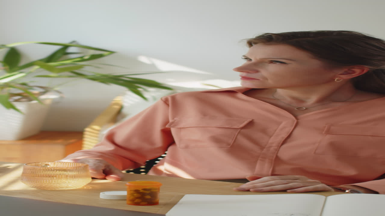 Stressed Woman Taking Pills at Work
