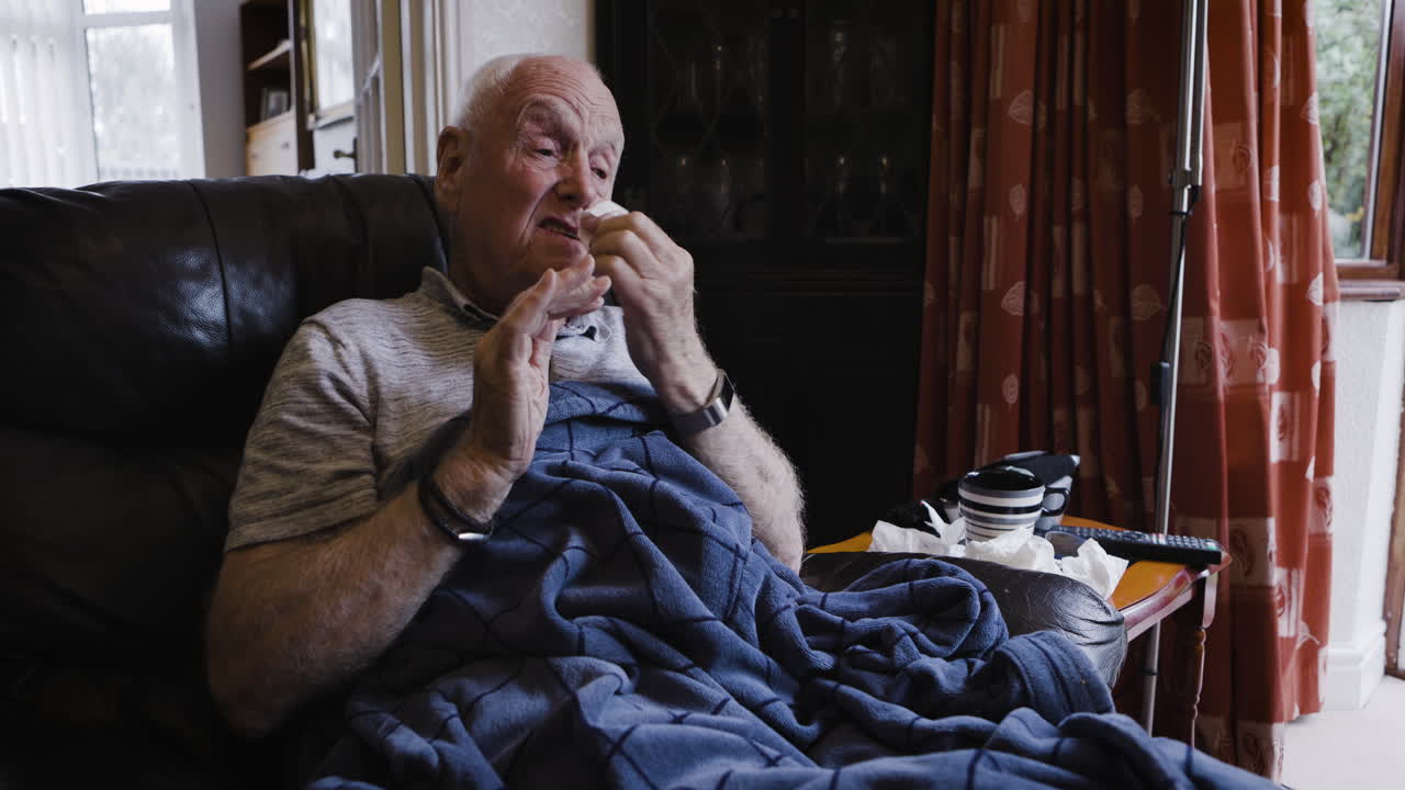 Elderly man at home with the flu
