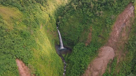 a stunning aerial view captures the beautiful catarata san fernando waterfall cascading into a vibrant, untouched green valley in costa rica