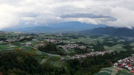 Rural-village-and-fields-in-Indonesia-landscape,-aerial-drone-view