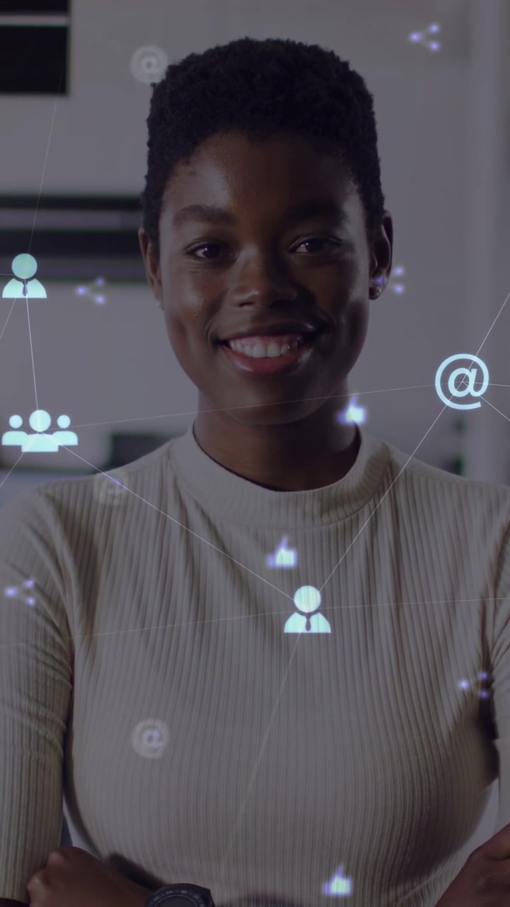 Vertical video: Woman standing in office, social media icons drifting, sparking smile into laugh