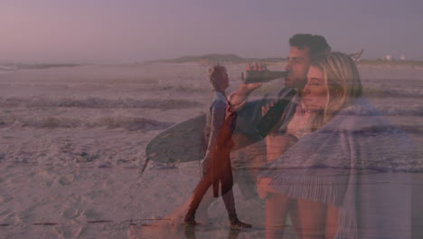 man and woman sipping bottles on dusk beach, overlaying surfer walking with surfboard for tourism