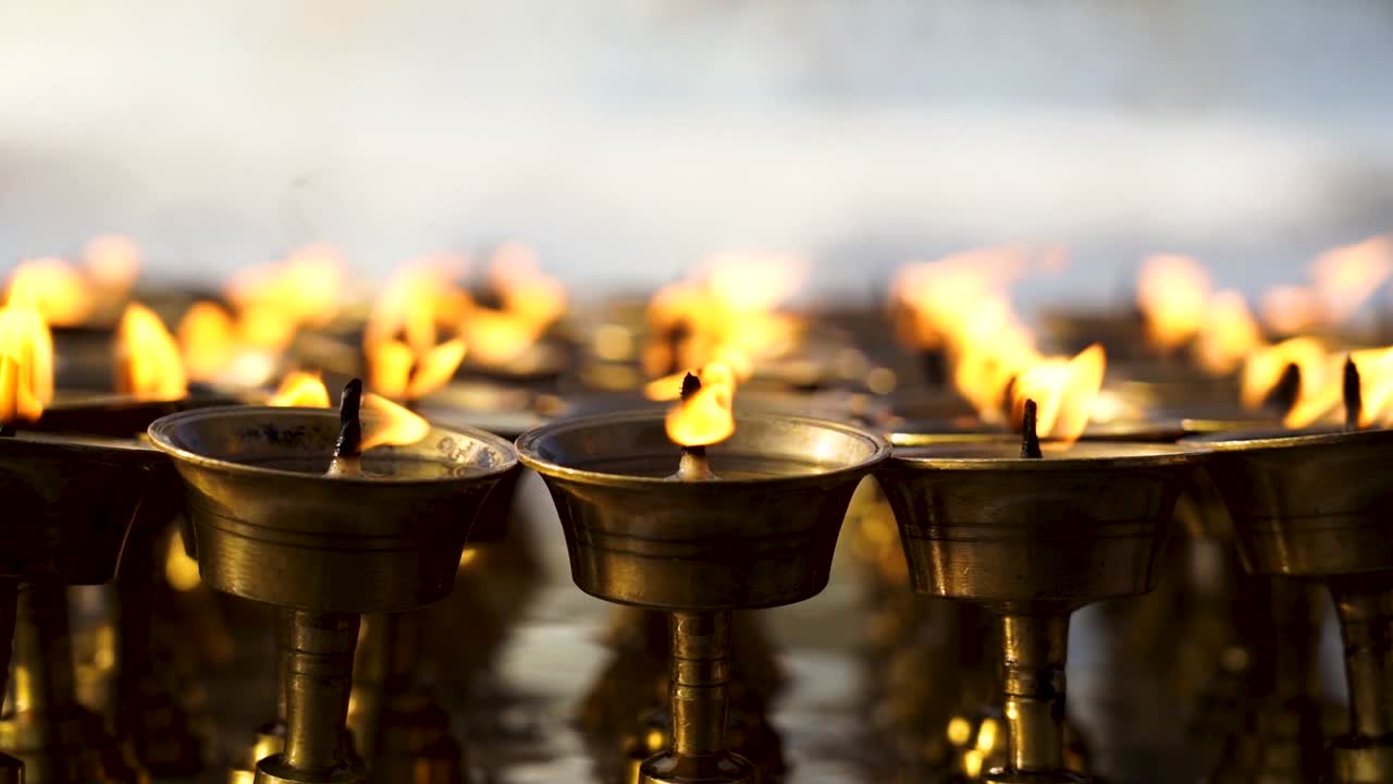 closeup view of burning earthern lamp in Baudhanath Stupa, Nepal