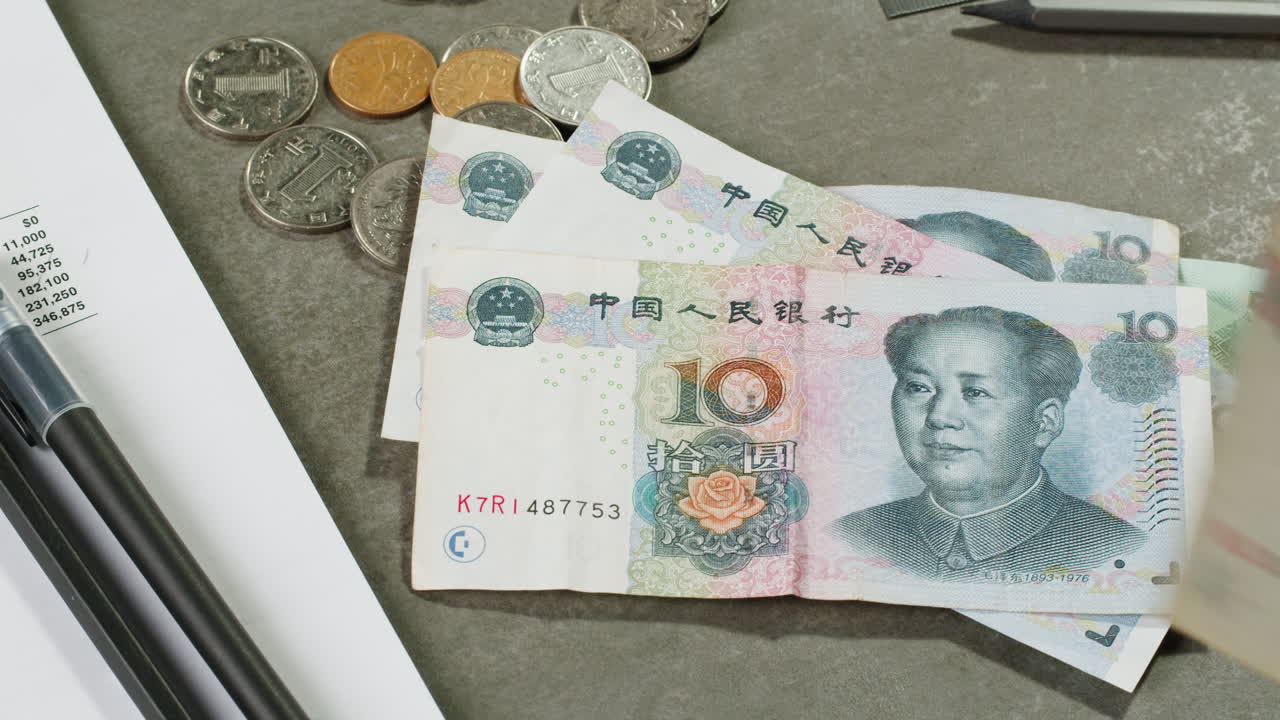 Chinese Yuan Bills and Coins on a Desk