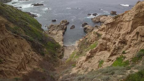 drone shot moving down canyon towards the pacific ocean on the california coast near highway one