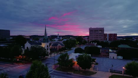 Columbus-cityscape-at-dusk-with-a-vibrant-sunset-and-skyline,-Georgia---Aerial