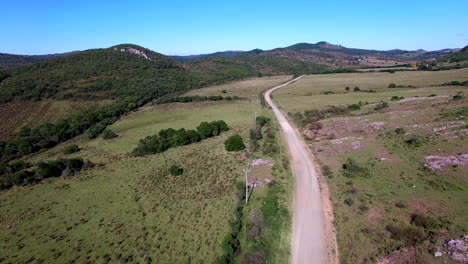 aerial footage tracking dirt road in the mountains near minas, uruguay